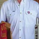 Poncho white Texas A&M short-sleeve button-down shirt featuring a structured collar, gold-tone buttons, two chest pockets, and a small maroon A&M logo embroidered on the front.