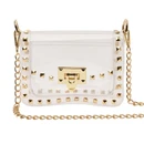Clear structured crossbody bag featuring gold-tone pyramid studs around the edges, a polished gold clasp closure, transparent flap front, and removable gold chain shoulder strap for game days and events.