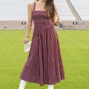 Maroon and white striped midi dress featuring wide shoulder straps, a square neckline, fitted smocked bodice, and full flowing skirt with vertical stripes throughout.
