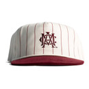 Concho Texas A&M cap featuring a cream crown with thin maroon vertical pinstripes, embroidered vintage A&M monogram, maroon top button, and contrasting maroon corduroy bill.