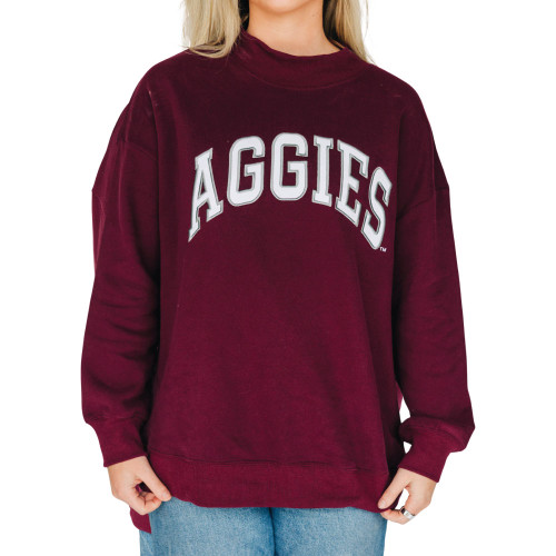 Scarlet & Gold Texas A&M maroon mockneck sweatshirt featuring arched Aggies lettering across the chest in white and gray.