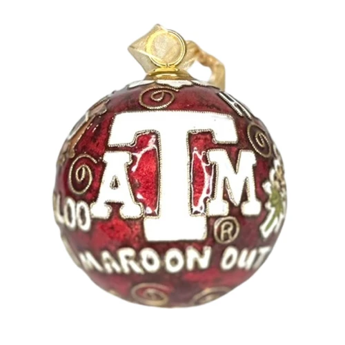 Kitty Keller round maroon Texas A&M Traditions ornament featuring a white A&M logo, gold accents, and Aggie sayings including Howdy, Gig ’Em, Whoop, Hullabaloo, Midnight Yell, Bonfire, and 1876.