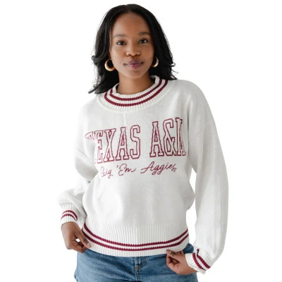 Gameday Social ivory Texas A&M sweater featuring maroon outlined Texas A&M lettering, Gig ’Em Aggies script, long sleeves, and maroon double-stripe accents along the neckline, cuffs, and ribbed hem.