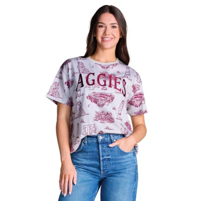 Stewart Simmons light gray Texas A&M tee featuring an allover maroon toile-style print with Reveille, Kyle Field, Century Tree, campus landmarks, A&M logos, and large Aggies lettering.