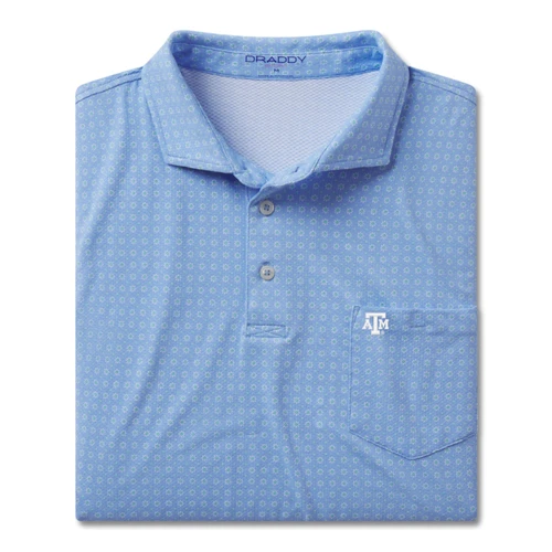 Light blue B. Draddy Texas A&M polo featuring an allover pattern of tiny green flowers, two-button placket, chest pocket, and white A&M logo for a polished Aggie look.