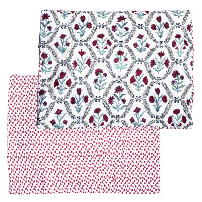Ida Mae standard pillow sham featuring maroon and red floral patterns, green botanical accents, decorative black scrollwork, and a coordinating printed backing on a white background.