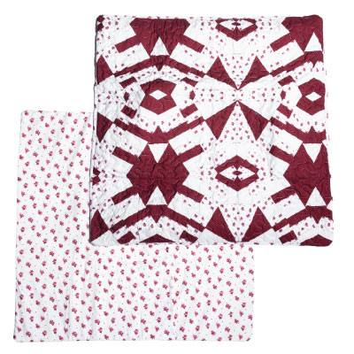 Ida Mae euro pillow sham featuring a maroon and white geometric patchwork pattern with quilted stitching on the front and a coordinating floral print backing on a white background.