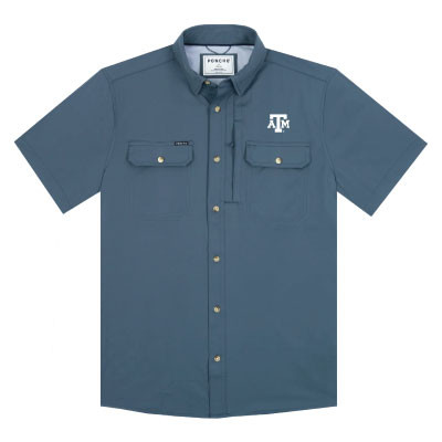 Slate blue Poncho short sleeve fishing shirt with an embroidered white Texas A&M logo on the left chest, button-front closure, dual chest pockets, and lightweight performance fabric designed for outdoor activities.