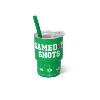 Swig Mini Shot Cup featuring a bright green football field design with white “Gameday Shots” lettering, yard-line markings, a clear lid, and coordinating green reusable straw.