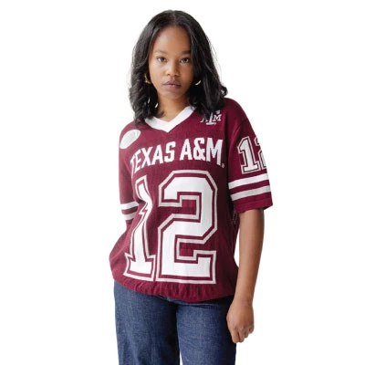 Gameday Social maroon Texas A&M sweater jersey featuring white Texas A&M lettering, oversized number 12 graphics, striped short sleeves, A&M logo, V-neckline, and Gig ’Em lettering across the back.