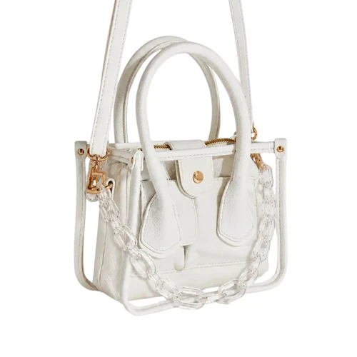 Clear mini handbag featuring white trim and top handles, gold-tone hardware, a removable white shoulder strap, clear acrylic chain accent, structured silhouette, and zippered top closure.