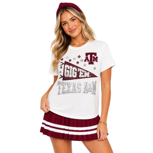 Brianna Cannon white Texas A&M short sleeve tee featuring a maroon Gig ’Em pennant, A&M logo, silver Texas A&M lettering, and scattered maroon and silver star accents across the front.