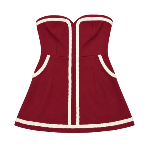 Women's maroon strapless sweetheart romper featuring cream braided trim along the neckline, center front, curved side pockets, and flared hem, with a fitted waist and feminine skirt-like silhouette.