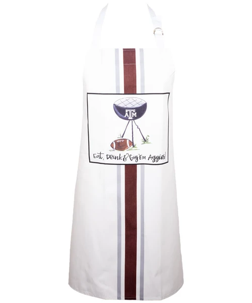 Magnolia Lane white Texas A&M kitchen apron with vertical maroon stripe and central graphic featuring an Aggies-themed design and “Eat Drink Gig ’em Aggies” text.