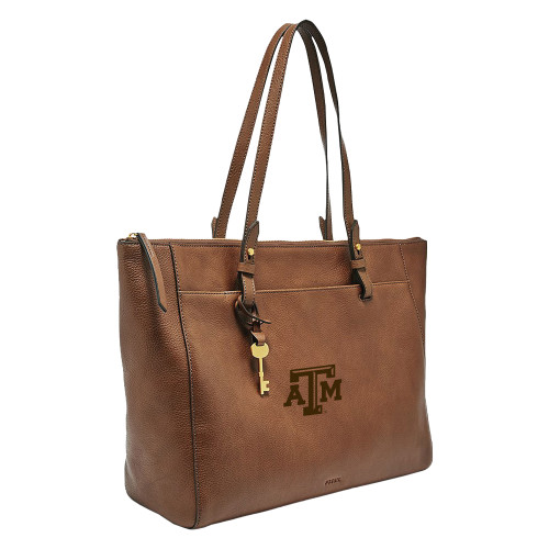 Fossil Texas A&M leather tote bag in brown with embossed Texas A&M logo on front, structured silhouette with dual shoulder straps and gold tone hardware for Aggies everyday use.