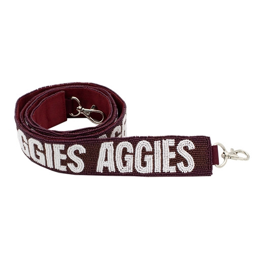 Maroon Capri Designs interchangeable purse strap featuring bold white “Aggies” lettering and silver hardware, styled as a Texas A&M Aggies game day handbag accessory.