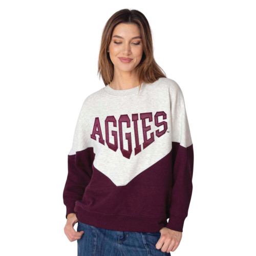 chicka-d Texas A&M Aggies maroon and cream colorblock sweatshirt featuring Aggies lettering across the chest modeled by athlete