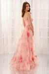 Back view of CL6167 showing flowing floral organza skirt and soft ruffle hem.