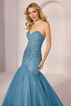 Three-quarter view of Morilee 49203 in blue showing beaded corset and flared glitter tulle skirt.