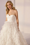 Close-up of ivory option showing soft ruffled tiers and strapless sweetheart bodice.