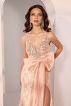Close-up front of Morilee 49241 in ballerina pink showing extended V-neck and detachable organza bow belt.