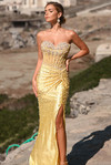 Yellow PS26002 strapless corset gown with pearls and high slit, outdoor setting.