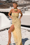 Yellow PS26011 floral embellished gown with thigh-high slit and rosette choker, outdoor view.