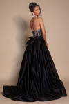 Black/silver PS26077 strapless ball gown with bow-accented waist and flowing train, studio back view.