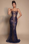 Model in navy Portia and Scarlett PS26095 wave pattern beaded fitted gown with draped scoop neckline, slender straps, and body-contouring sheer beaded mesh.