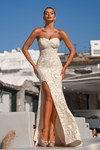 Model wearing PS26175 ivory lace gown with floral embroidery and front slit.