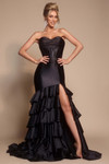 Front view of XO085 in black featuring dramatic ruffled skirt and high slit.