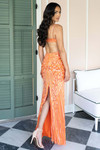 Tangerine beaded fitted gown with open back and modern slit, shot in natural light.