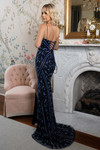 Rachel Allan 70958 Navy Periwinkle — indoor profile view by fireplace emphasizing curve-sculpting fit and lace up back.