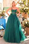 Model wearing an emerald strapless ball gown with a lace semi-sheer corset bodice and glitter tulle skirt.