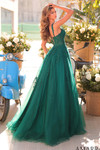 Back view of emerald ball gown featuring lace appliques, lace-up corset back, and full glitter tulle skirt.