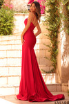 Back view of the red jersey gown showing the lace-up back and long fitted skirt.