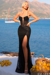 Model wearing a black fully embellished fitted gown with a plunging sweetheart neckline, spaghetti straps, and high slit.