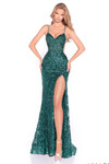 Model wearing an emerald sequin lace fitted prom dress with sheer mesh side panels.