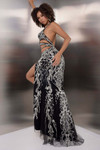 Side view of Jasz Couture 7900 in black showcasing the open back, strappy midsection, and detailed beaded lace pattern.