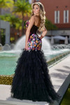 Jasz Couture 7901 in Black/Multi back view displaying straight across back with zipper closure, colorful floral appliques on bodice, and cascading black tulle ruffle tiers