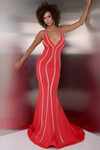 Model in red Jasz Couture 7903 highlighting the plunging neckline, contour beadwork, and flared hem.