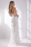 Back view of the white beaded gown highlighting the fitted silhouette and sparkle details.