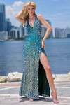 Model wearing a teal fully beaded halter gown with 3D petals, plunging neckline, and high slit.