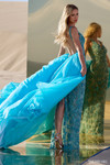 Sherri Hill 56390 in Aqua showing open low back and dramatic overskirt train.