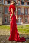 Sherri Hill 56855 in Red showing mid-open back and fitted silhouette with train.