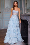 Sherri Hill 57739 in Light Blue with sheer stone embellished corset bodice, dainty bow, and cascading ruffle tiers.