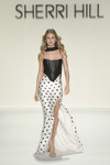 Sherri Hill 57987 in Black/Ivory with strapless corset top and polka dot fitted skirt with slit.