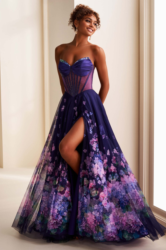 Ellie Wilde EW37003 front view—Dark Purple/Multi A-line with beaded sheer corset, thigh-high slit, floral skirt.
