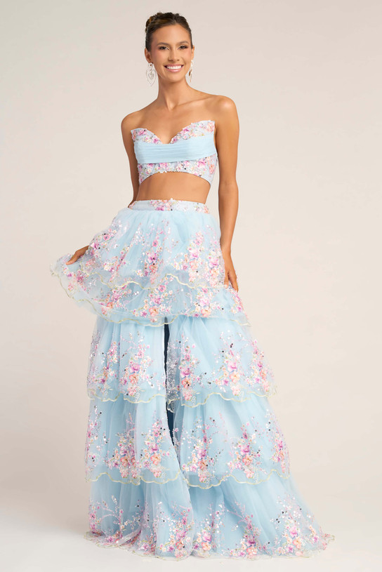 Model wearing Portia and Scarlett PS26272 blue two-piece floral embroidered prom dress with tiered tulle skirt.