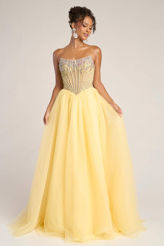 Model wearing Portia & Scarlett XO047 in yellow, featuring a strapless beaded corset bodice and flowing tulle A-line skirt.